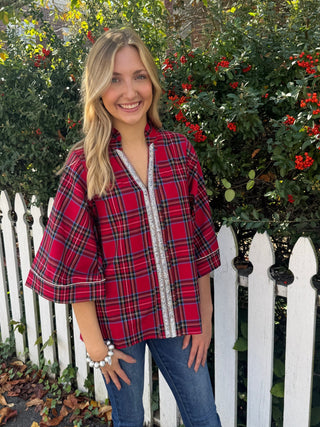 plaid blouse with a ruffled neckline, 3/4 length wide sleeves, and rhinestone details