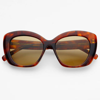 Cat-eye sunglasses with a translucent tortoiseshell frame in brown and amber tones, paired with brown-tinted lenses.