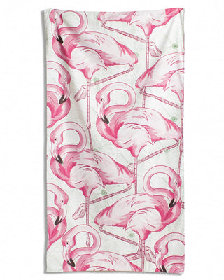 Beach towel with pink flamingo pattern.