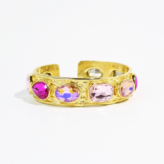 Gold bracelet with colorful gemstones by Treasure Jewels.