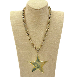 Gold chain necklace with a star pendant.
