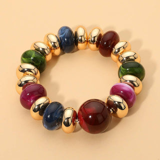 Multicolored beaded bracelet with gold accents.