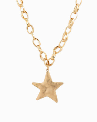 Gold star pendant on a gold chain necklace.