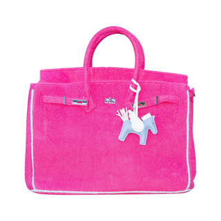 Pink bag with a small white and blue horse charm.