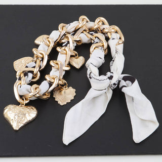 Gold chain with heart charms and a white scarf necklace