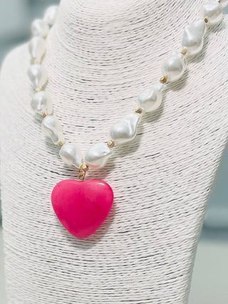 Necklace with white pearls and a pink heart pendant 