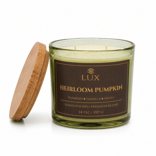 A 14 oz green glass candle jar with a brown label reading 'LUX Heirloom Pumpkin' and a light wood lid. It is  pumpkin and vanilla scented.