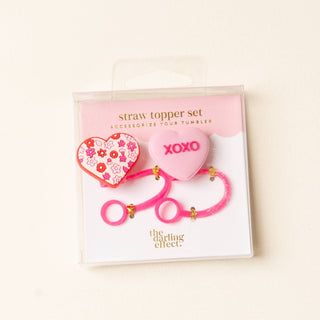 Heart-shaped straw toppers with floral design and 'XOXO' text in packaging 