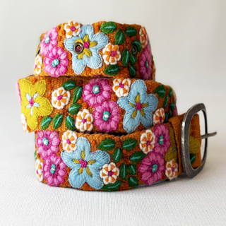 Colorful floral-patterned wool belt with a metal buckle.