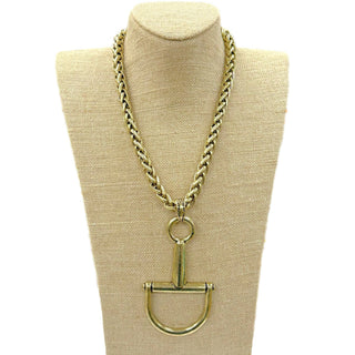 Gold chain necklace with a unique snaffle bit pendant.