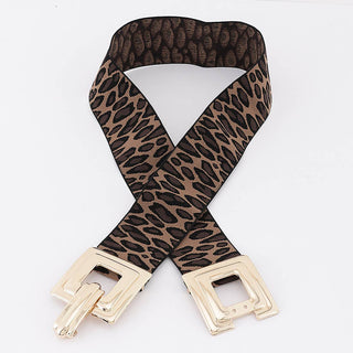 A leopard print stretch belt with a brown and black pattern and shiny gold square interlocking buckles.