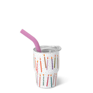 Shot tumbler with birthday candle design and pink straw.