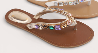 Brown sandal with colorful gemstones.