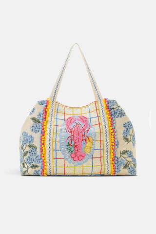 Colorful handbag with floral patterns and a pink lobster design. 