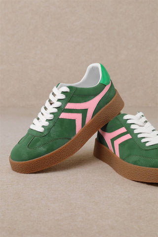 Green low top sneakers with pink accents.