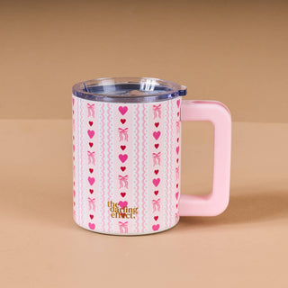Pink insulated mug with heart and bow pattern 