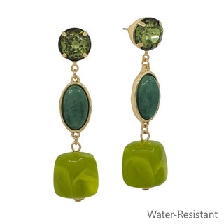 A pair of gold-tone drop earrings featuring green gemstone accents and a large lime-green bead at the bottom and are Water-Resistant.