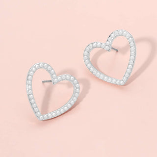 Heart-shaped earrings with pearl detail.