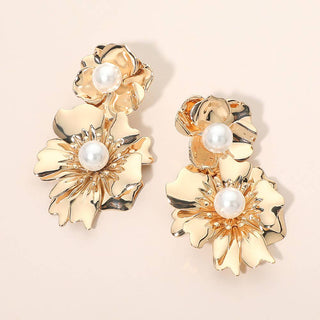 Gold floral earrings with pearl centers.