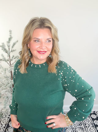 green sweater with pearls