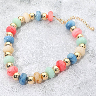 Multicolored beaded necklace with gold accents.