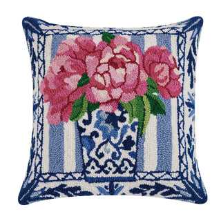 Decorative pillow with pink flowers and blue patterns.