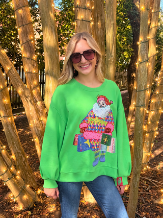 queen of sparkles green sweatshirt with colorful santa with shopping bags