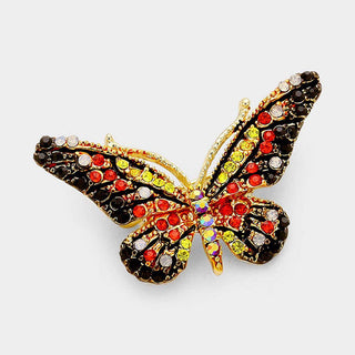 Butterfly-shaped brooch with multicolored gemstones.