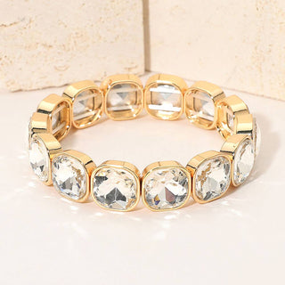 Gold bracelet with clear gemstones.