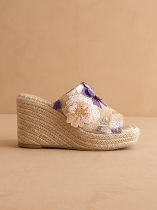 Woven wedge sandal with floral design.