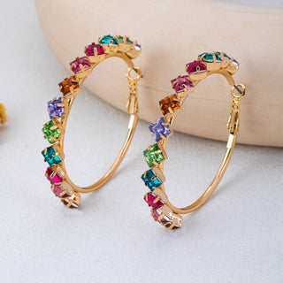 Gold hoop earrings adorned with colorful square-cut rhinestones in pink, green, blue, purple, and orange.