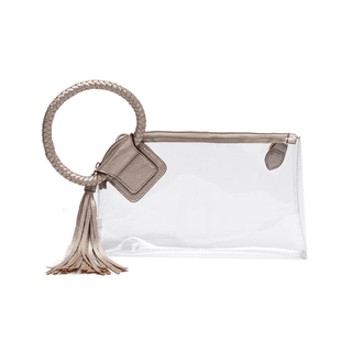 A clear plastic wristlet with champagne gold trim and a detachable shoulder strap, featuring a zip top closure and gold-tone hardware.