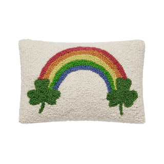 Decorative pillow with a rainbow and shamrocks.