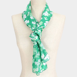 Green scarf with white clover pattern.