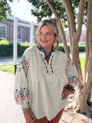 Easel top with floral embroidery across a relaxed dolman-sleeve