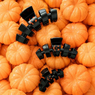 ThreeSpooky Smiles teleties claw-style hair clips with orange Halloween jack-o'-lantern faces.