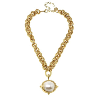 A gold chain necklace with a large oval pendant featuring a white pearl in a gold bezel setting.