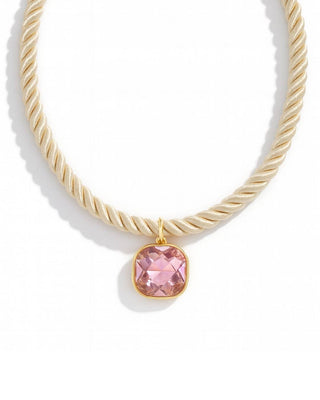 Ivory colored rope necklace with a pink gemstone 
