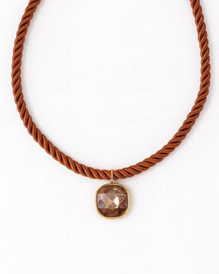 Rust colored rope necklace with a square pendant 