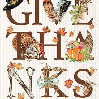 A Thanksgiving-themed decorative guest towel with large brown letters spelling parts of the phrase, decorated with autumn illustrations including a turkey, pumpkins, leaves, feathers, a cornucopia, a hat, utensils, and fall leaves on a cream striped background.