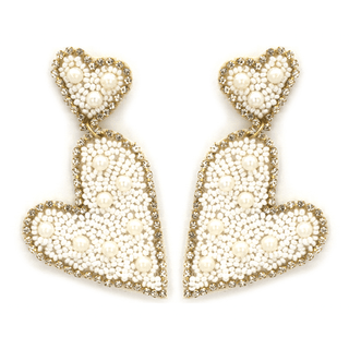 Heart-shaped earrings with seed beads and pearl details.