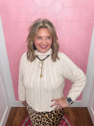 cream mock neck cable knit sweater