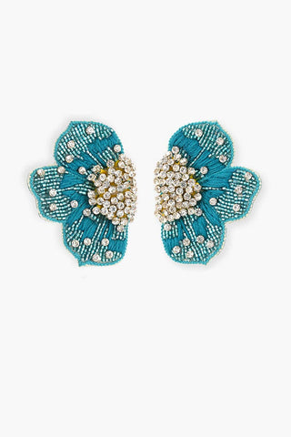 Pair of turquoise floral earrings by america & Beyond.