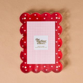 Red scalloped magnetic photo frame with heart patterns 