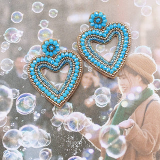 Heart-shaped earrings with blue beads.