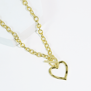 Gold plated chain necklace with a heart-shaped pendant with toggle closure.