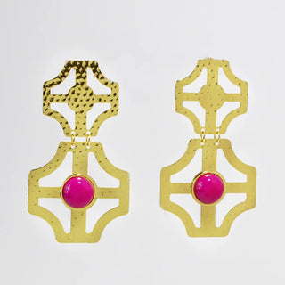 Gold earrings with hot pink central stones.