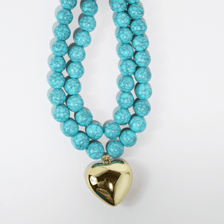 Treasure Jewels turquoise beaded necklace with a gold heart pendant.