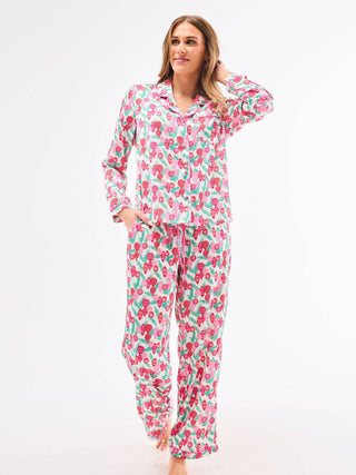 Woman wearing a christmas ornament pajama set 