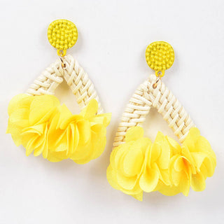 Yellow floral earrings with woven triangles. 